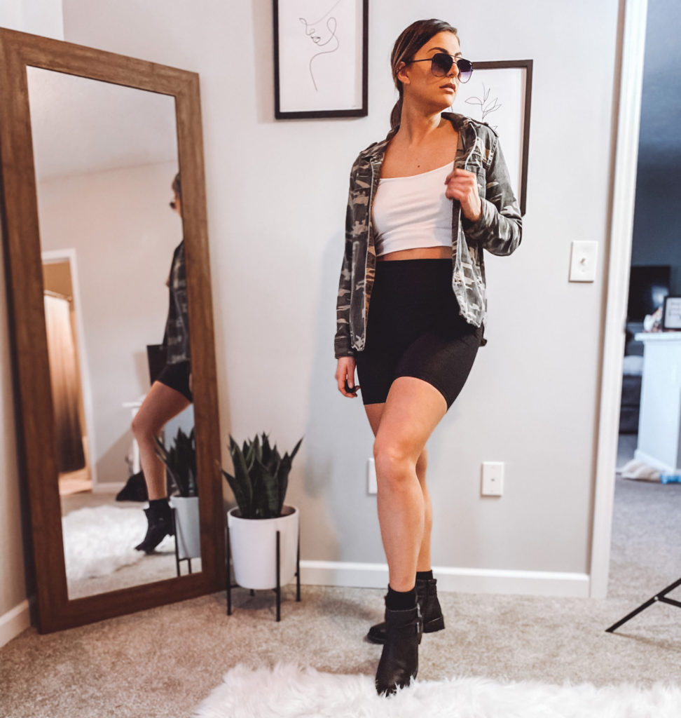Bike shorts paired with combat boots, crop top and camo jacket